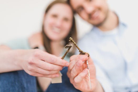 happy couple holding keys to their new home