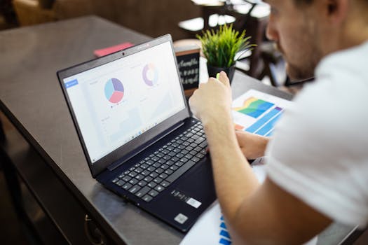 person using laptop to review financial data