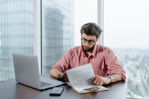 person reviewing mortgage documents at a desk