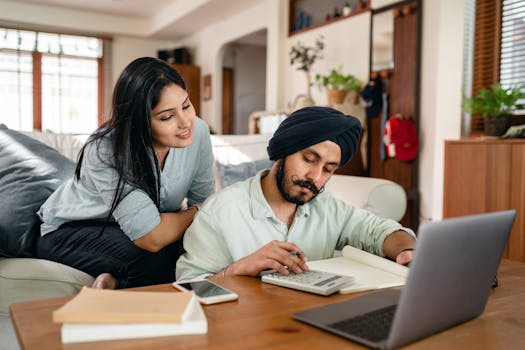 couple using a calculator to plan finances