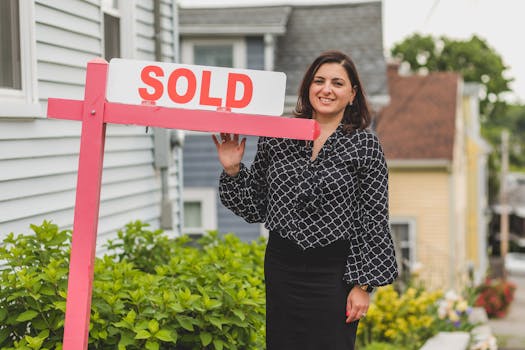 house with a sold sign and auction gavel