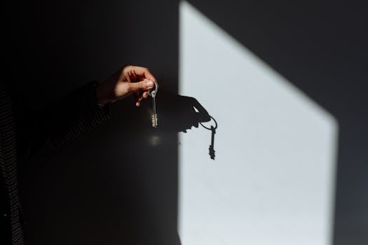 person holding a house key and documents